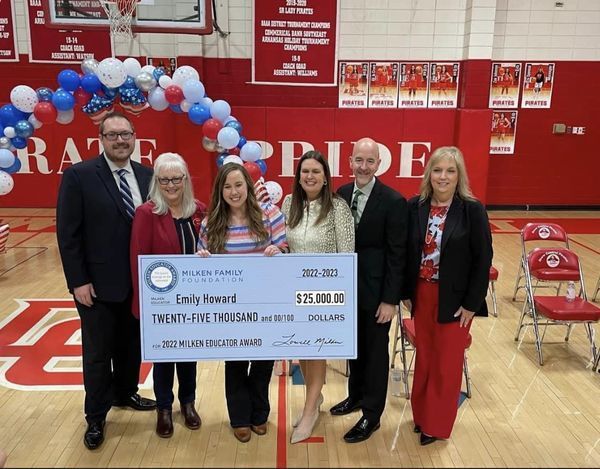 Emily Howard in the gym with the governor and secretary of education